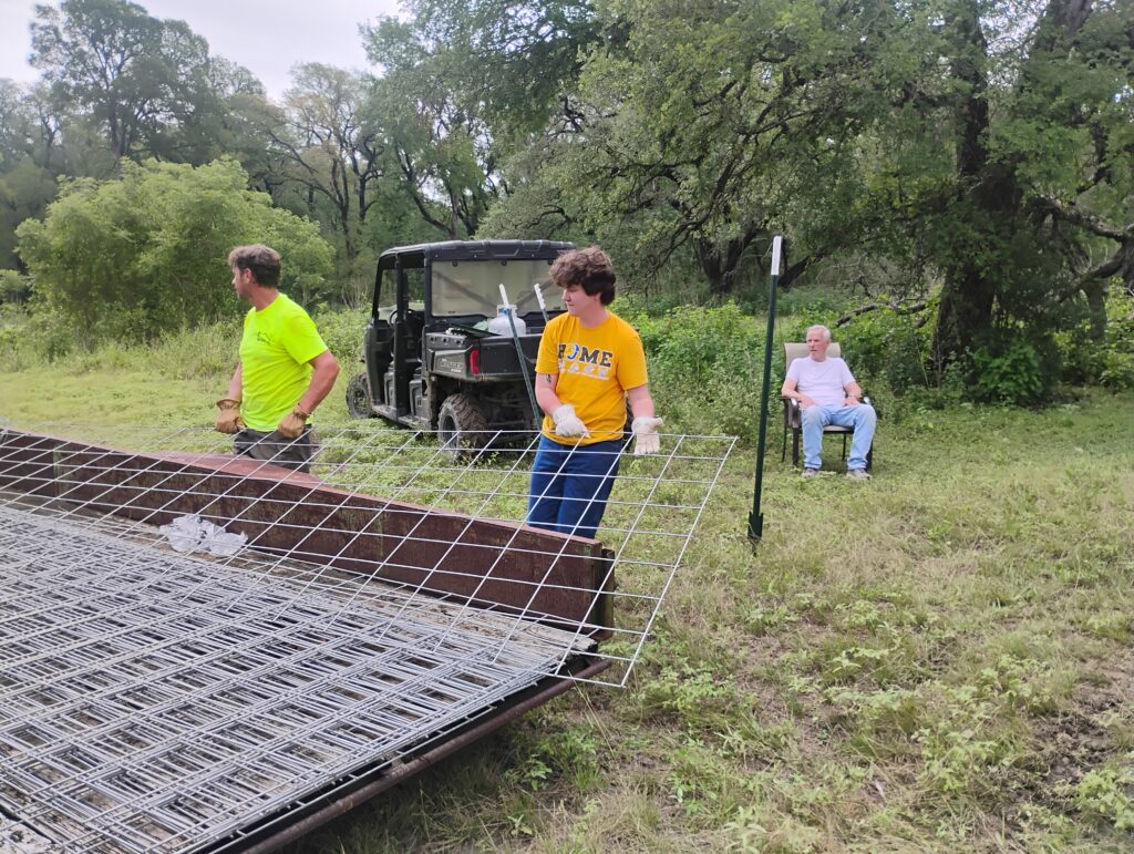 Building fence at Scurlock Farms after flood damage