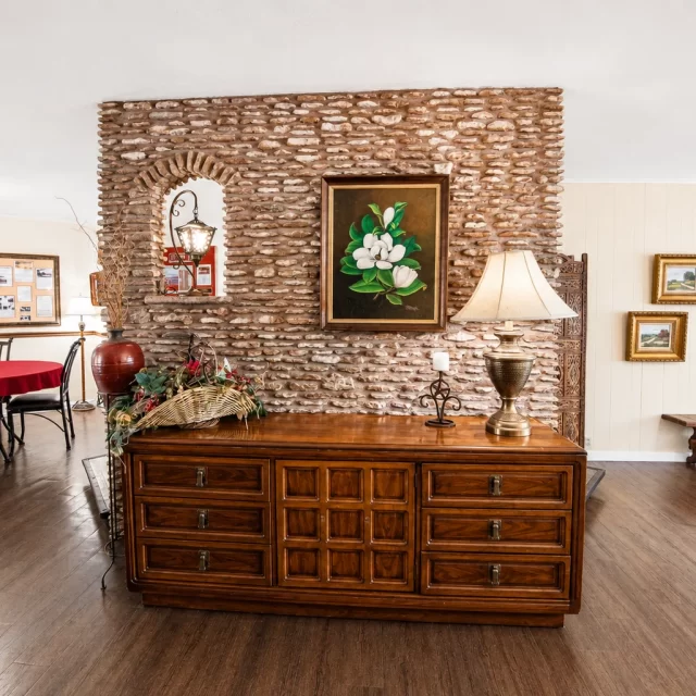 Spacious living room with exposed brick accent wall in Georgetown cabin rental at Scurlock Farms