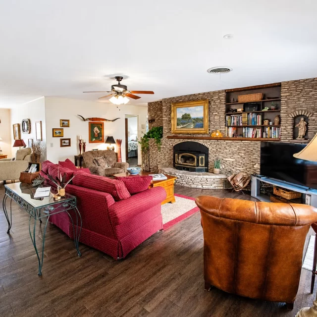 Spacious living room with stone fireplace and rustic decor at Scurlock Farms Georgetown