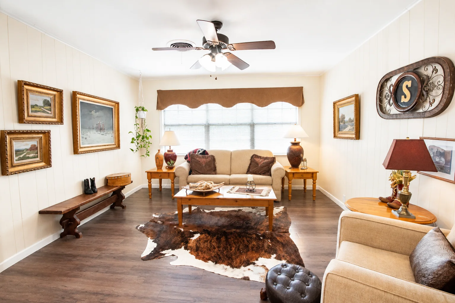 Elegant rustic living room with beige sofa and western decor at Scurlock Farms Georgetown